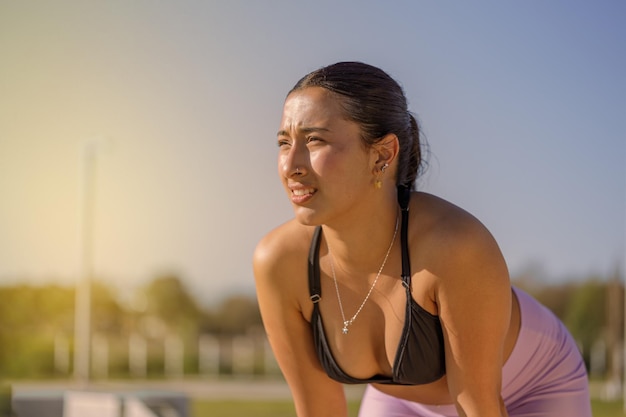 Latin girl taking a break after running