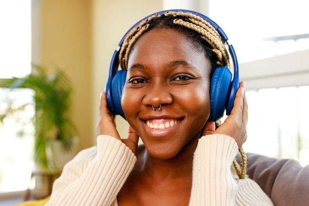 Latin hispanic woman listen music while sitting on sofa in
living room