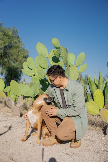 Latin man and his dog in mexican countryside