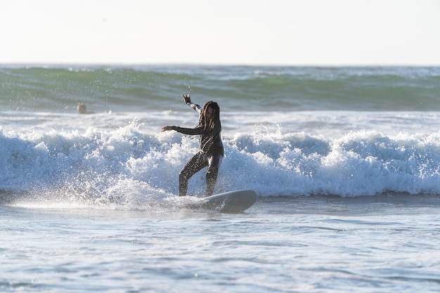 Latin man surfing the wave in La Serena Chile