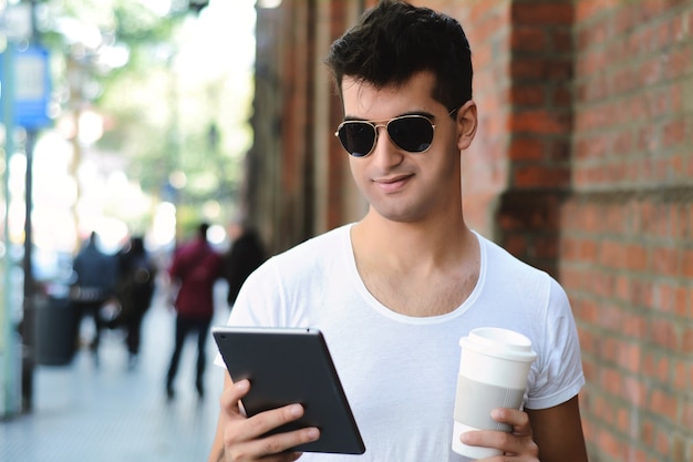 Latin man using a tablet.