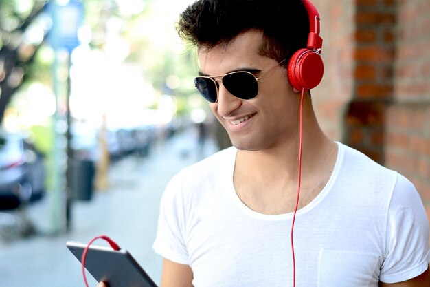 Latin man using a tablet.