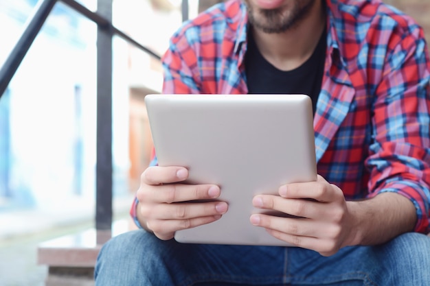 Latin man using a tablet.