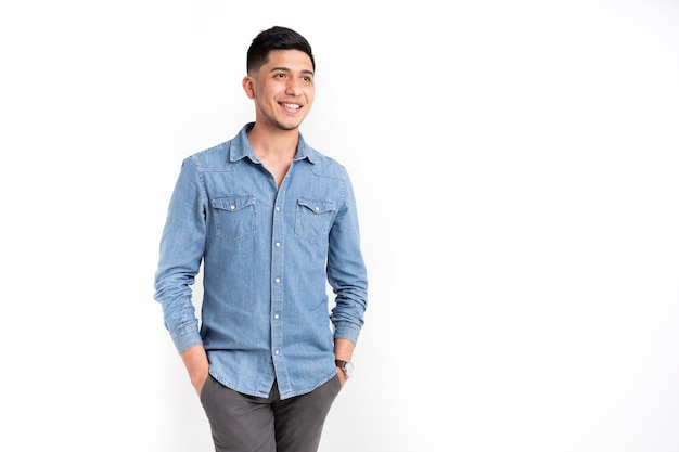 Latin man with hands in pocket smiling