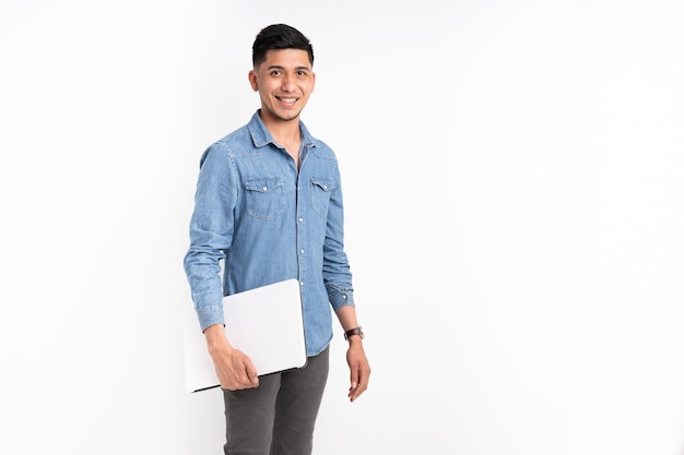 Latin man with laptop in hands looking and smiling