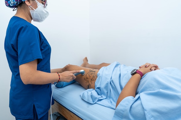 Latin physiotherapist giving rehabilitation to a patient