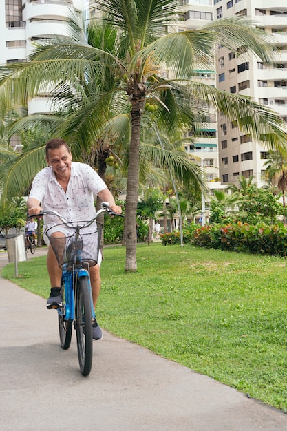 Latin Senior man on park bike ride