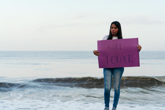 Latin Woman Holding A Feminist Banner.