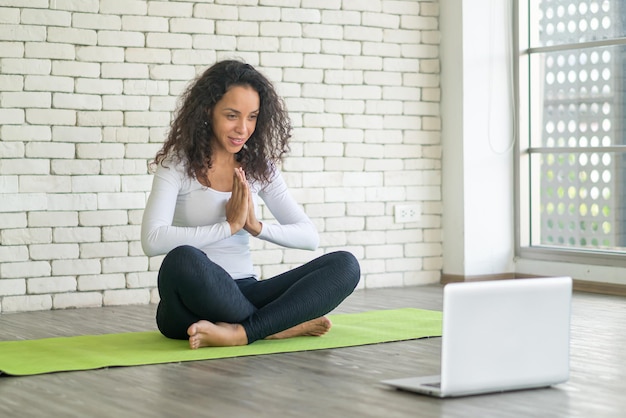 Latin woman influencer teaching yoga online