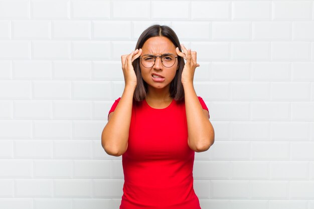 Latin woman looking concentrated or with headache