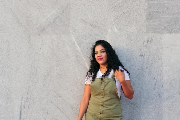 Latin woman smiling on city street