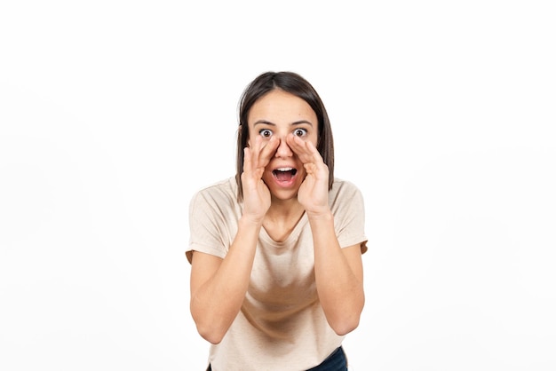 A latin woman telling a secret with two hands on her mouth.