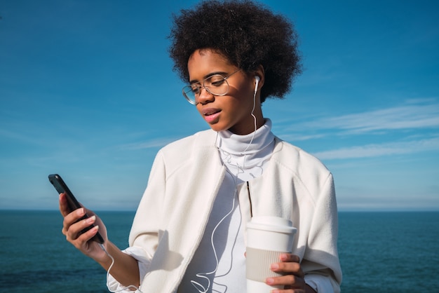 Latin woman using mobile phone.