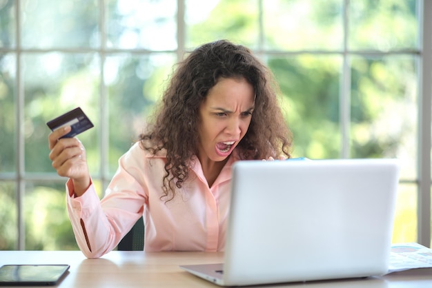 Photo latin woman yelling at the bank employee not happy with her credit card balance.