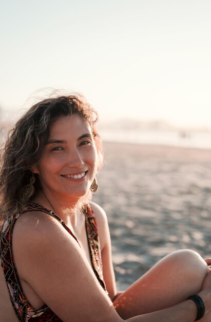 Latin young woman happy smiling on the beach looking at camera portrait in La Serena