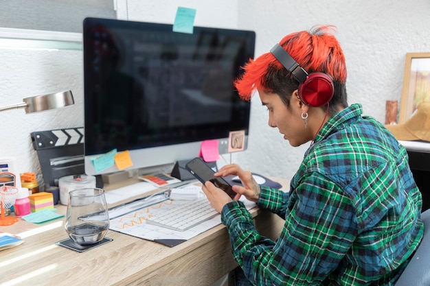 Photo latina woman working from home sends text messages from cell phone