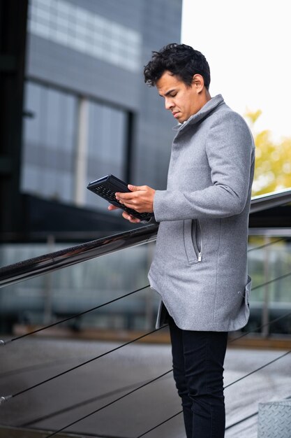 Latino man stadsbeeld tablet modieuze kleding