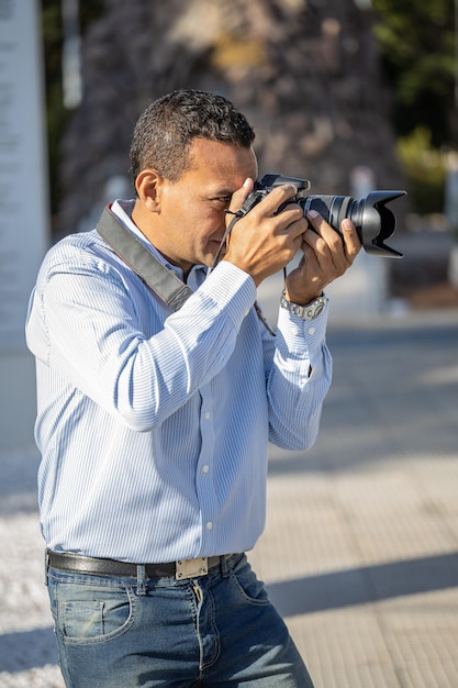 Latino photographer taking a picture on the street