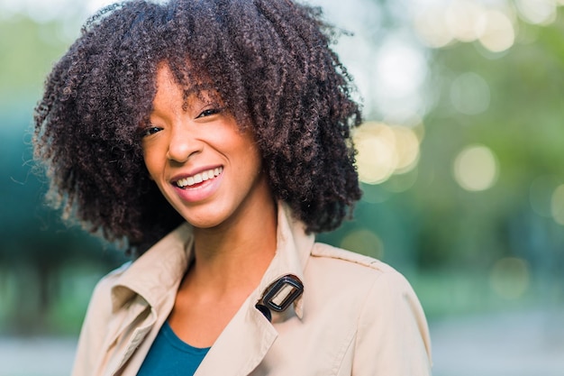 Latinx caribbean young woman with curly hair smile happy people beautiful in winter