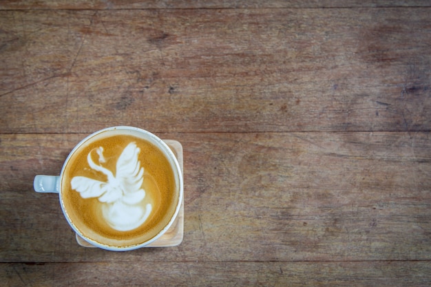 latte art coffe on wood table