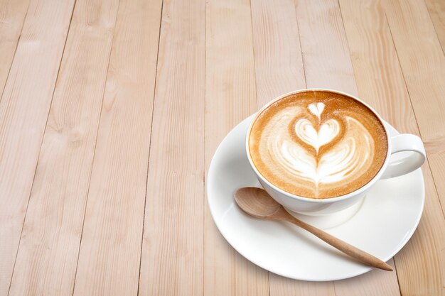 Latte art coffee on wood background