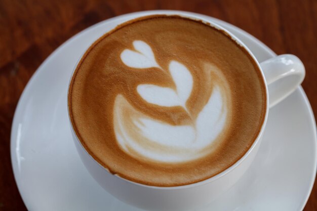 Latte art coffee on wood table