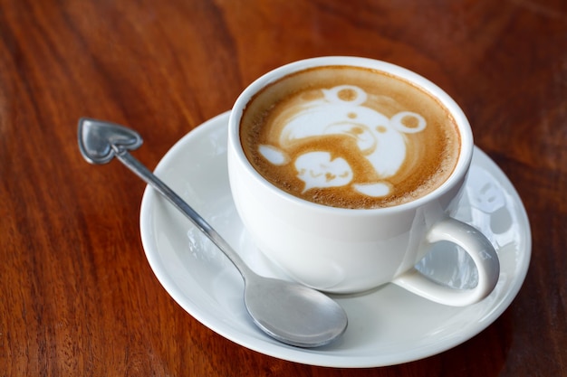 Latte art coffee on wood table