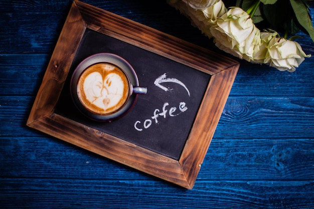 Latte art in the cup of cappuchino - loving couple