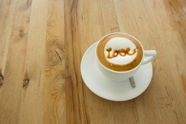 A Latte Coffee art on the wooden desk.A cup of coffee,coffee Art.