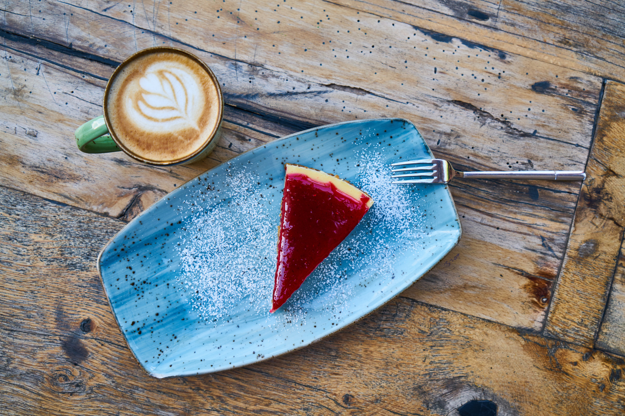 Latte coffee and cheesecake on a table