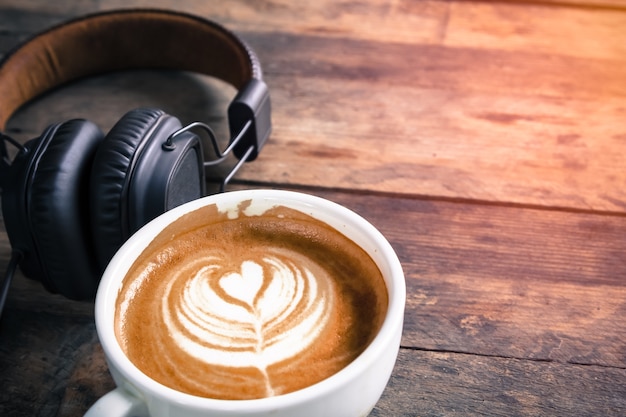 latte coffee cup and headphone on table