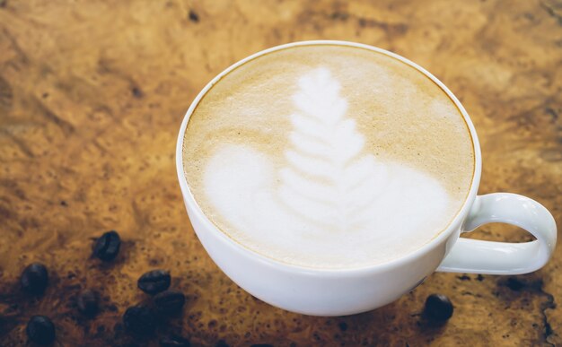 Latte coffee cup on wooden table