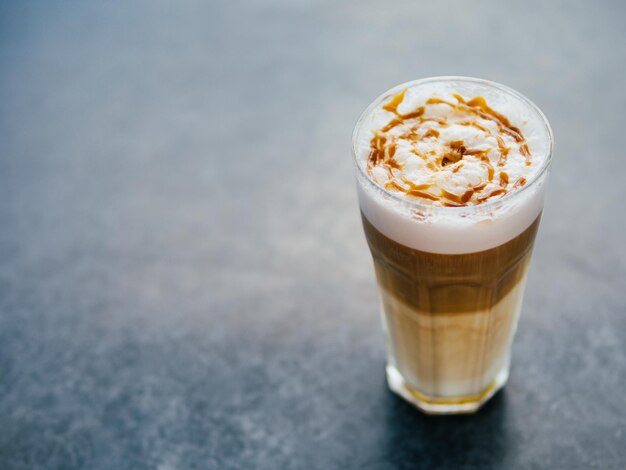 Latte macchiato coffee on tabletop copy space