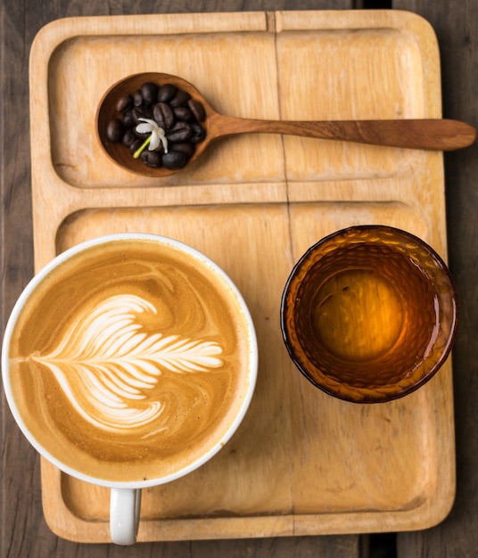 Latte Milk cream flower Wooden spoon coffee bean Background