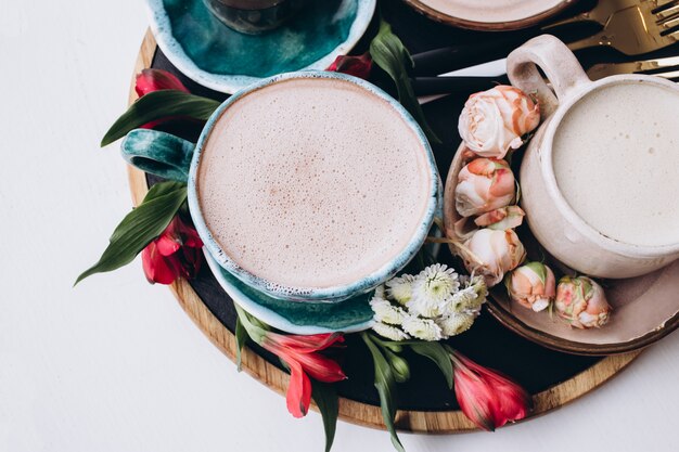 Latte op een witte tafel met bloemen