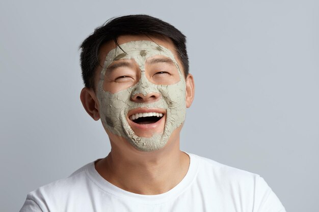 Laughing Asian Man Face Mask Relaxed Man On Natural Cosmetic Mud Procedure