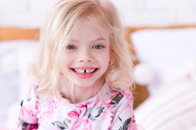 Laughing baby girl with dental smile wearing stylish birthday dress