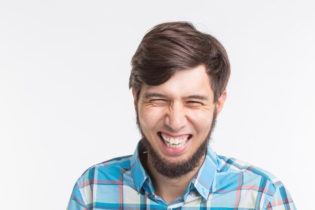 Laughing bearded handsome man on white background
