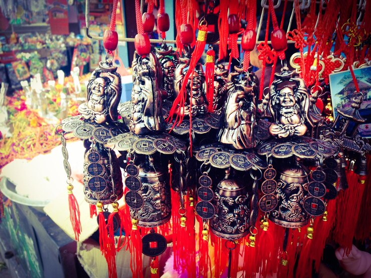 Photo laughing buddha wind bells for sale at street market