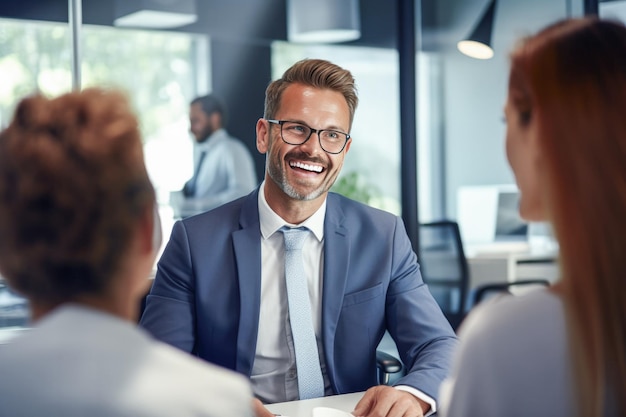 Laughing businessman sitting at table with anonymous women