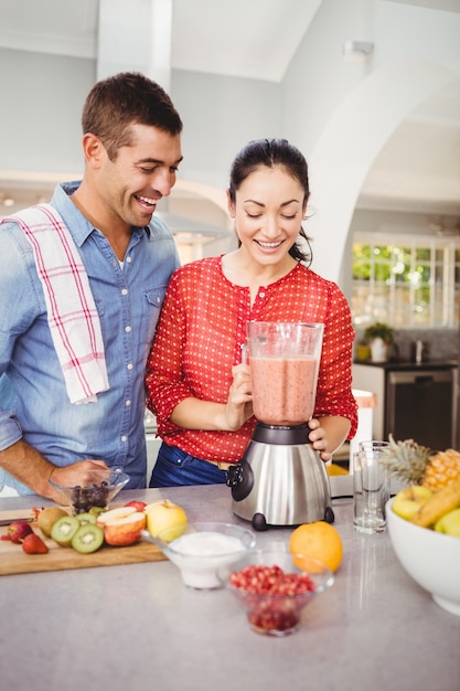 Laughing couple with fruit juice