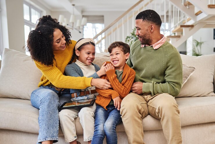 Photo laughing family and children in home with winter fashion parents or support with smile or foster care bonding funny or happy kids with love adoption and warm clothes to relax or play in canada