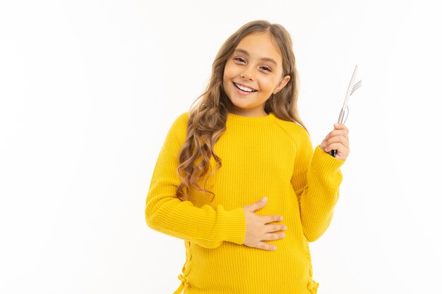 Laughing girl with cutlery on white with copyspace