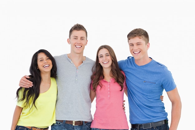 A laughing group of friends look at the camera 