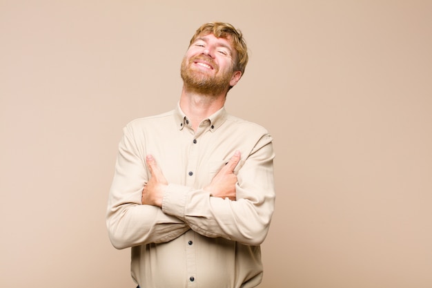 laughing happily with arms crossed, with a relaxed, positive and satisfied pose