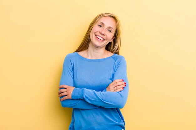 Laughing happily with arms crossed with a relaxed positive and satisfied pose