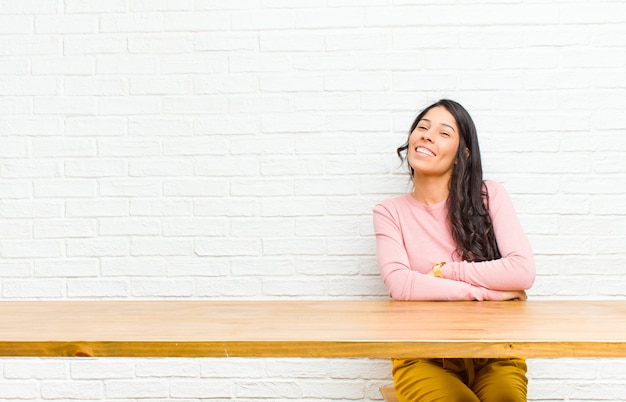 laughing happily with arms crossed, with a relaxed, positive and satisfied pose