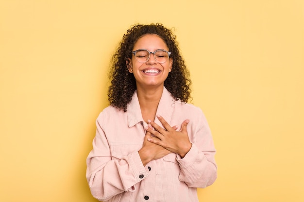 Photo laughing keeping hands on heart concept of happiness