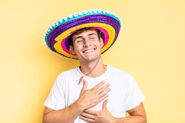 Laughing out loud at some hilarious joke, feeling happy and cheerful, having fun. mexican hat concept