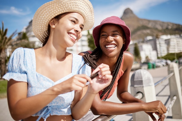 Laughing phone or fashion women bonding on summer holiday in South Africa city travel location Smile happy or comic friends students or tourist with trend style clothes or social media 5g mobile